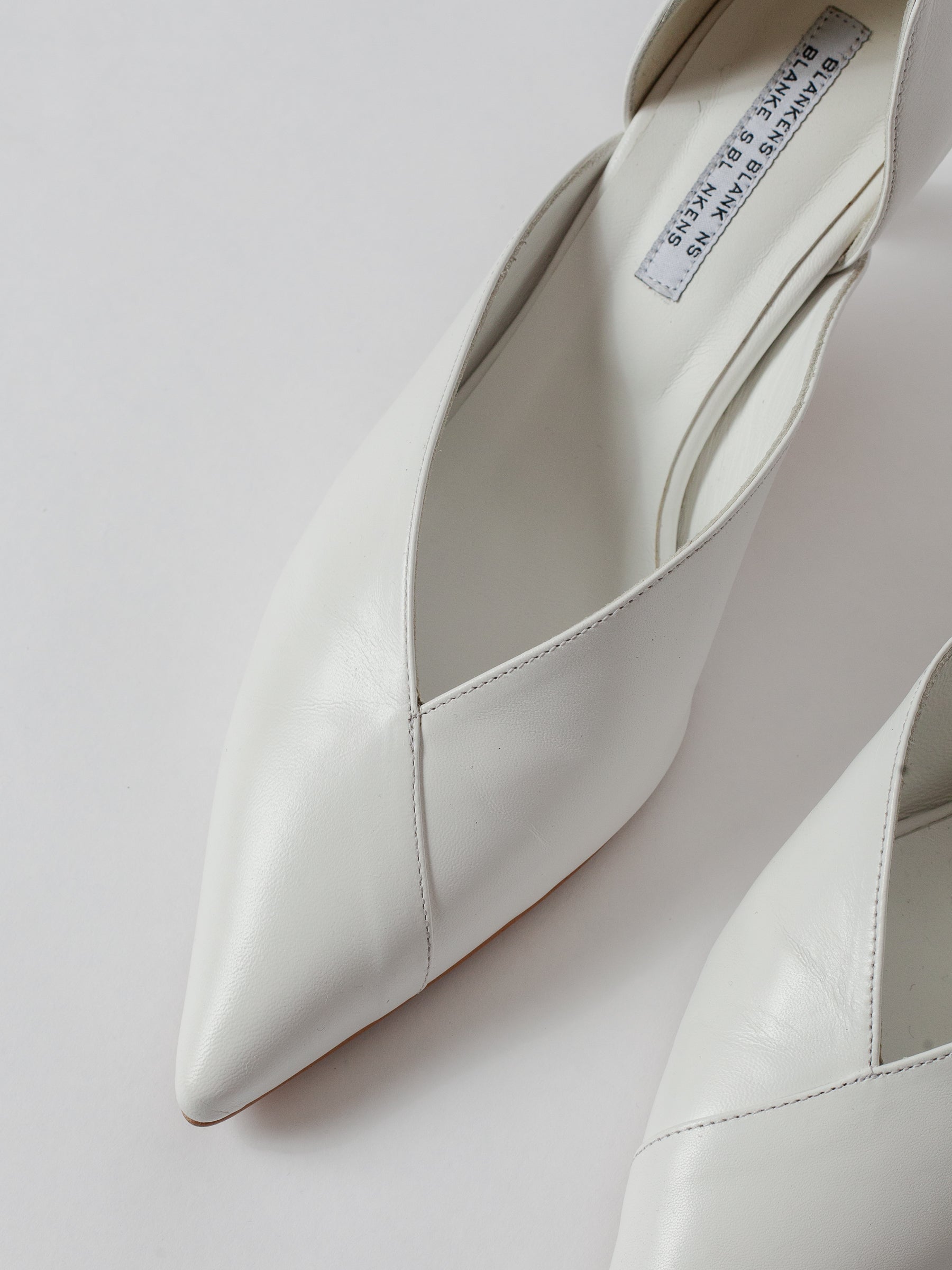Blankens The Radford white White high-heeled shoes on a light gray background Weddings shoes White pointed-toe shoes on a light gray background