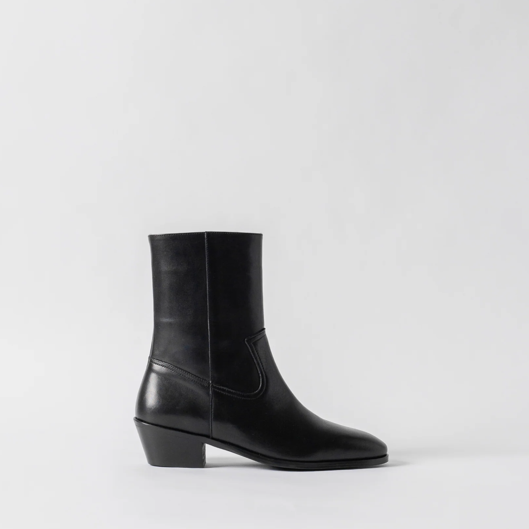 Black leather ankle boot on a light gray background