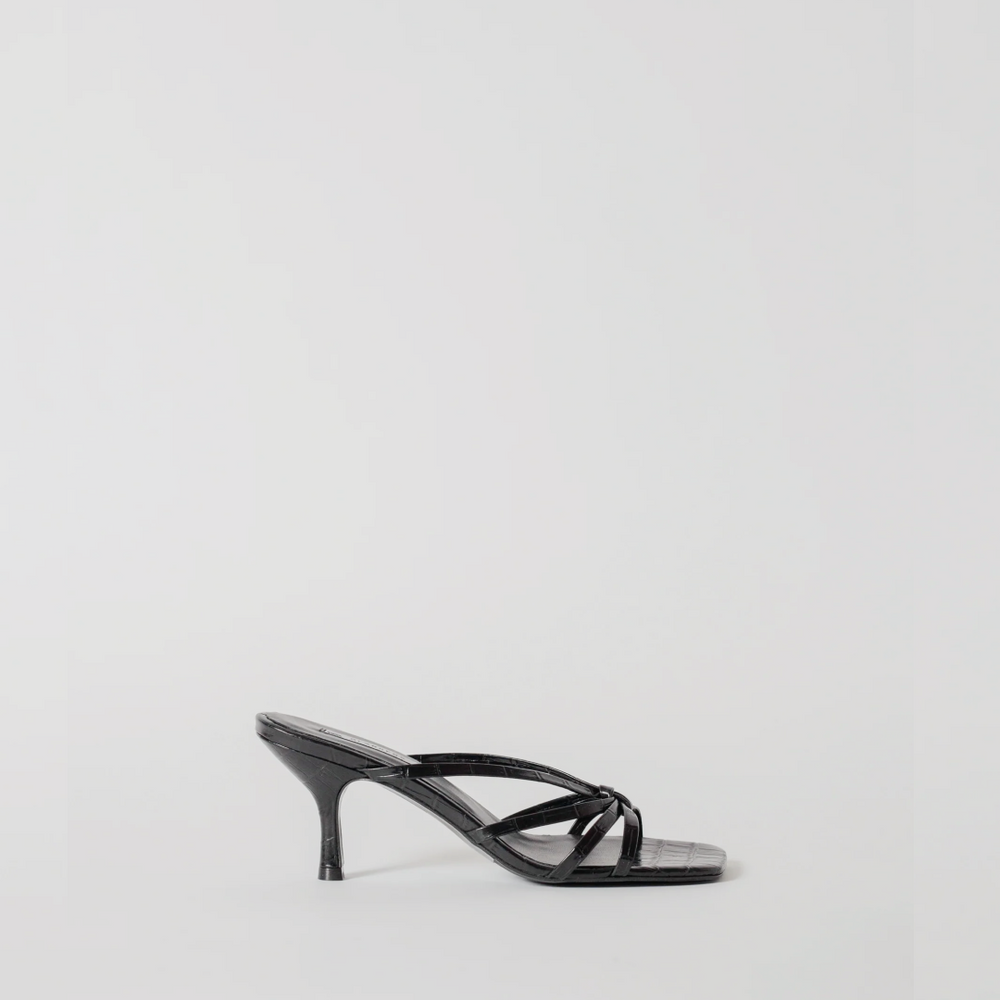 Black high-heeled sandal on a light gray background