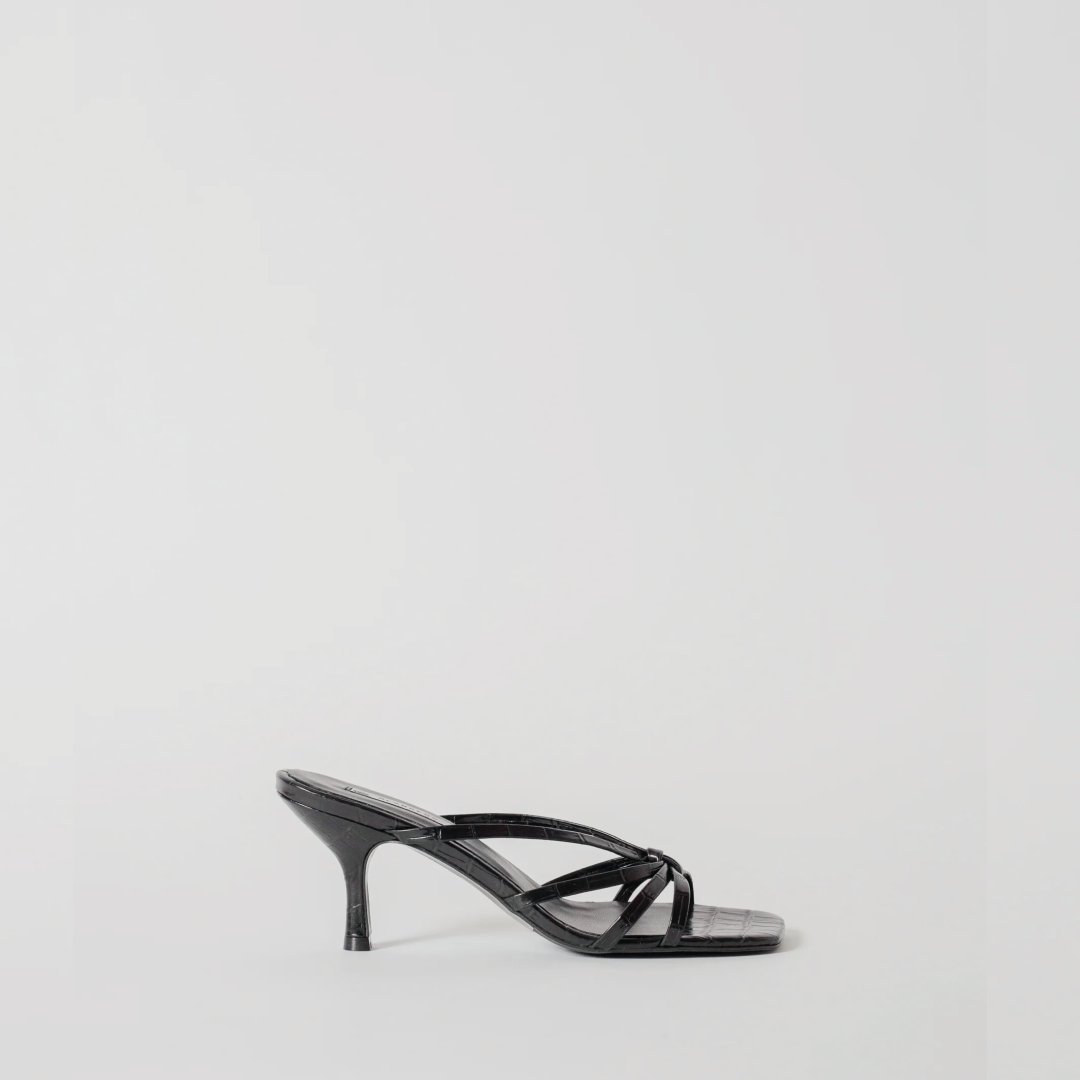 Black high-heeled sandal on a light gray background