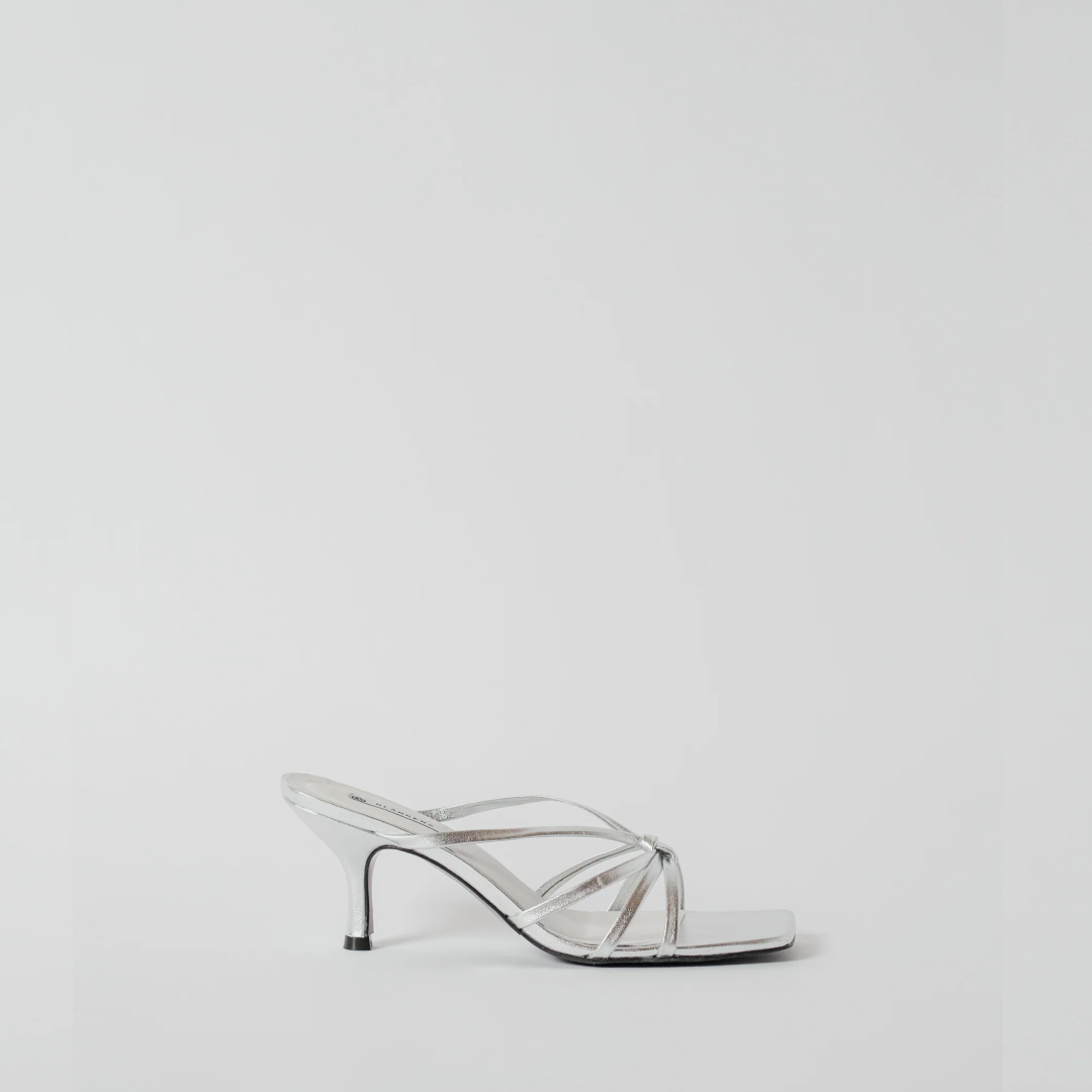Clear high-heeled shoe on a light gray background